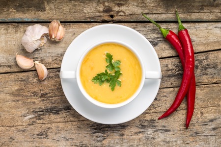 Pea soup with spices on wood background. Top Viewの写真素材