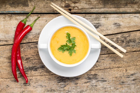 Creative cuisine. Pea Soup with chopstick on wood backgroundの写真素材