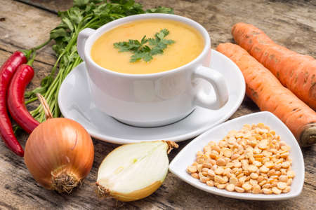 Pea soup with ingredients on wood backgroundの写真素材