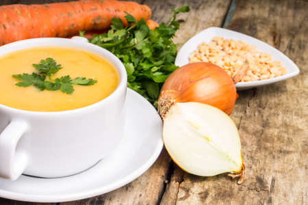 Pea soup with ingredients on wood backgroundの写真素材