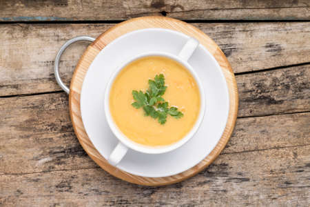 Pea soup in White Bowl on grunge wood background. Top Viewの写真素材