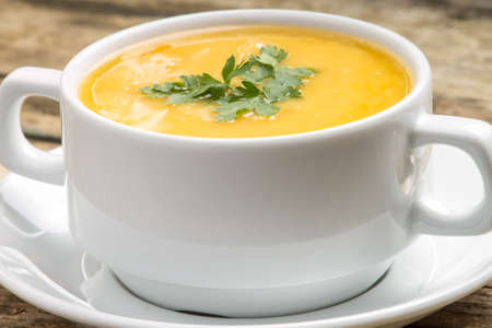 Organic food. Pea soup in white bowl on wood backgroundの写真素材