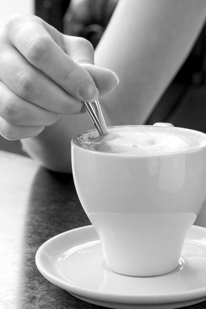 Morning coffee. Cup of Cappuccino in Cafe. Black and White imageの写真素材