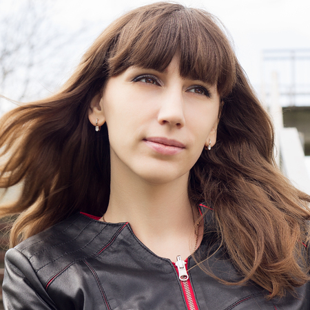 Young brunette woman looking straight ahead or waiting for somebodyの写真素材