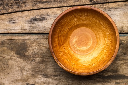 Ceramic bowl on wood background. Top viewの写真素材