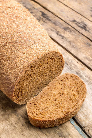 Rye bread laying on the old wood table.の写真素材
