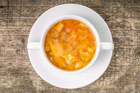Fish soup in white bowl on wood backgroundの写真素材