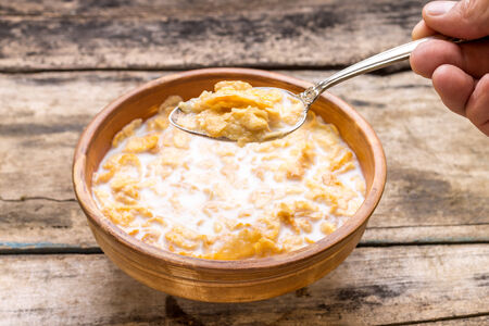 Clay bowl of corn flakes. Healthy eating background