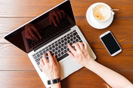 Mock up image of coffee break with laptop and smartphone overhead view