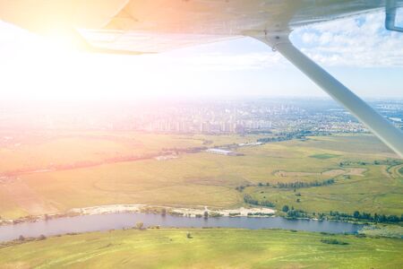 Aerial view from plane on river and big cityの写真素材