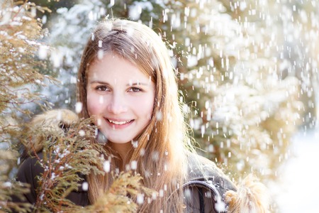 Young girl having fun in winter parkの写真素材