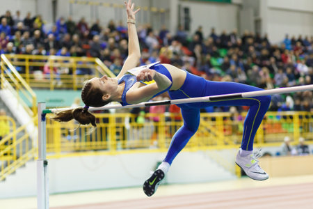 SUMY, UKRAINE - FEBRUARY 17, 2017: Yuliya Chumachenko jumping over bar in final High Jump competition of Ukrainian indoor track and field championship 2017.のeditorial素材
