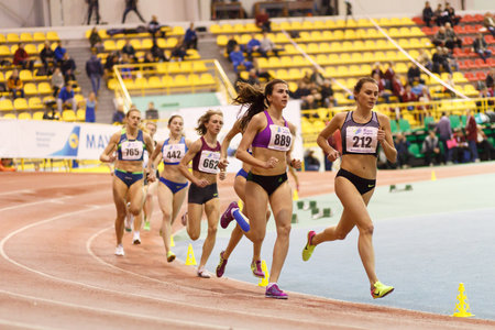 SUMY, UKRAINE - FEBRUARY 17, 2017: Mariya Shatalova ()212) and Olena Sokur (889) with other sportswomen running in final of 3000m race on Ukrainian indoor track and field championship 2017.のeditorial素材