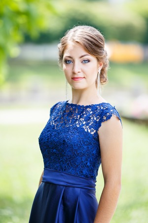 Portrait of young elegant lady in blue dressの写真素材