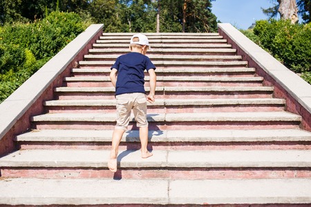 Children going up on stairs barefoot. Concept childhood image with copy spaceの写真素材