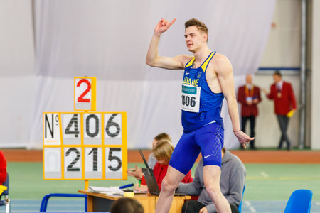 SUMY, UKRAINE - JANUARY 28, 2018: Vadym Kravchuk wins in high jump competition on Ukrainian indoor track and field team championship 2018のeditorial素材
