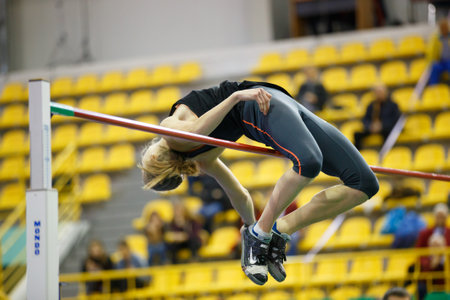 SUMY, UKRAINE - FEBRUARY 9, 2018: Alina Shukh - winner of pentathlon competition on Ukrainian indoor track and field championship 2018 performing high jumpのeditorial素材