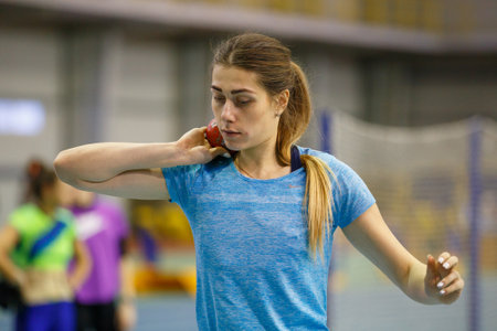 SUMY, UKRAINE - FEBRUARY 9, 2018: Yulia Marchenko performing shot put attempt in pentathlon competition on Ukrainian indoor track and field championship 2018のeditorial素材
