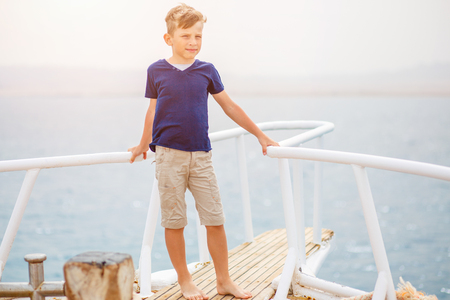 Small boy enjoying summer vacation on seaの写真素材