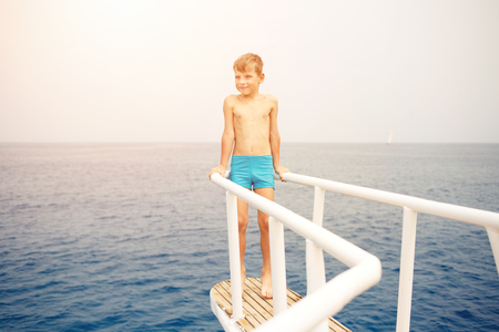 Small boy enjoying summer vacation on seaの写真素材