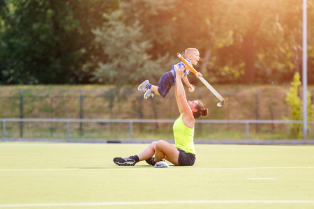 Small boy training playing field hockeyの写真素材