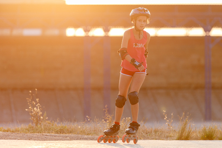 Young teenage girl speed skating on rollerdromeの写真素材