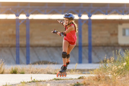 Young teenage girl speed skating on rollerdromeの写真素材