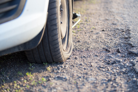 flat tire with damaged disc after got into a pit. Bad road backgroundの写真素材