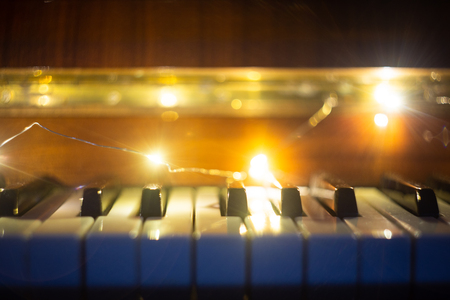 Piano keyboard illuminated with christmas lightsの写真素材