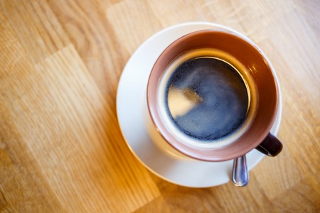 Cup of black coffee on the table in cafeの写真素材