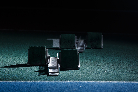 Starting blocks in dark before sprint start line