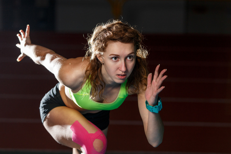 Female athlete starting her sprint race runningの写真素材