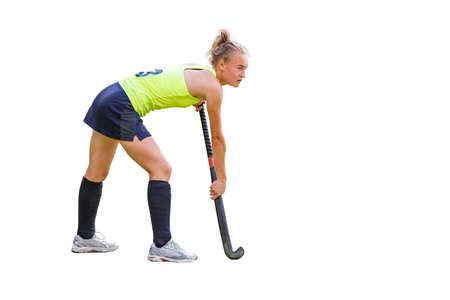 Young slim field hockey player girl with stick isolated on white background.の写真素材