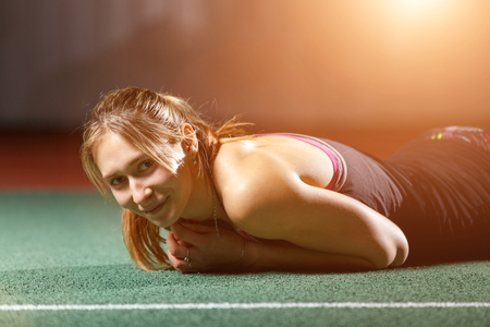 Young sportswoman relaxing on floor after trainingの写真素材