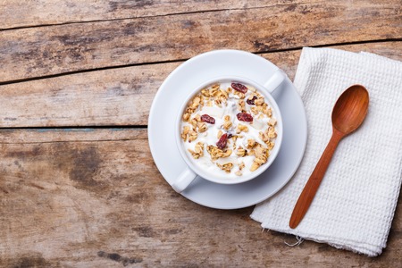 Muesli with yoghurt in white bowl. Healthy fitness breakfast backgroundの写真素材