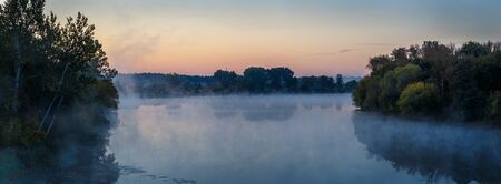 Landscape of autumn misty morning on the river.