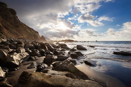 Coast of Tenerife with black sand and huge stonesの写真素材
