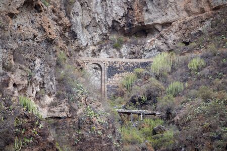 Old aqueduct in ravine Barranco del Infernoの写真素材