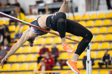 SUMY, UKRAINE - FEBRUARY 21, 2020: pentathlon sportswoman flying in high jump attempt at Ukrainian indoor track and field championship 2020.のeditorial素材