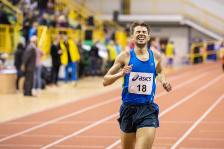 SUMY, UKRAINE - FEBRUARY 21, 2020: Volodymyr Kyts finishing 3000m race at Ukrainian indoor track and...