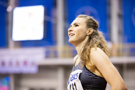 SUMY, UKRAINE - FEBRUARY 21, 2020: happy Tetyana Melnyk champion in 400m race after the finish at...