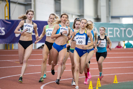 SUMY, UKRAINE - FEBRUARY 22, 2020: sportswomen run 3000m steeplechase at Ukrainian indoor track and field championship 2020.のeditorial素材