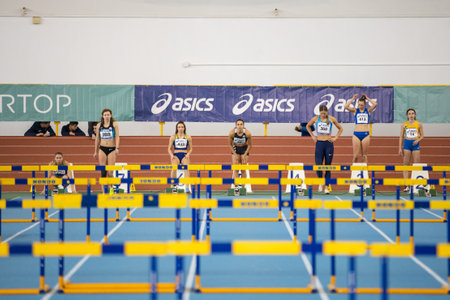SUMY, UKRAINE - FEBRUARY 22, 2020: Sportswomen at the start in final 60m hurdles contest at Ukrainian indoor track and field championship 2020.のeditorial素材