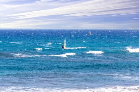Winsurfers on the waves of Atlantic ocean.の写真素材