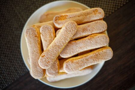 Savoiardi biscuits cookies on the plate with copy spaceの写真素材