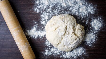 Raised piece of dough for making pizza ready for kneading with roller pin. Baking pizza top viewbackgroundの写真素材
