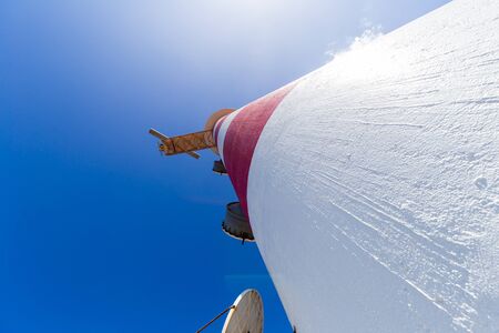 Wide angle view at the lighthouse tower against blue skyの写真素材