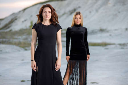 Portrait of two young women in black dresses at outdoorsの写真素材
