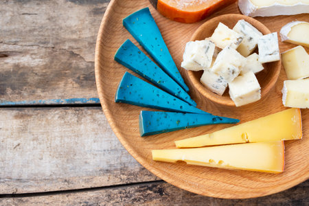 Close up image of different kinds of cheese on board. Cheese set with copy spaceの写真素材