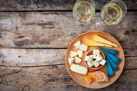 Top view cheeseboard with glasses of wine on the table with copyspace. Menu or wine card backgroundの写真素材